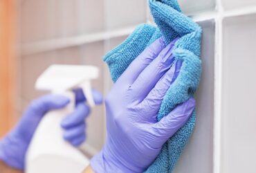 Woman at work, professional maid cleaning in office against virus desease