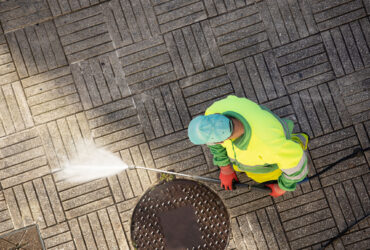 worker-cleaning-a-street-sidewalk-with-high-pressu-2025-02-20-23-52-45-utc